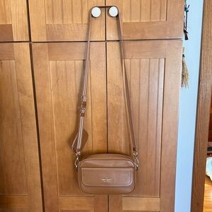 Kate Spade cognac Leather Crossbody Bag with webbed strap and coin purse.